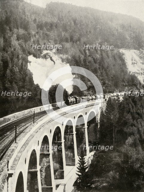 'In the Semmering Valley, Austria. A good train crossing the curved Gamperl Viaduct', 1935-36. Creator: Unknown.