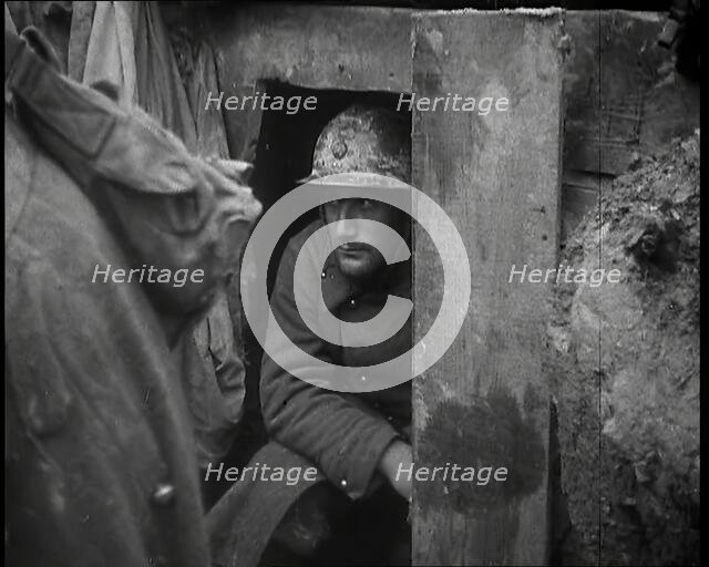 A Male French Soldier Sitting in a Doorway Dug into the Side of a Trench, 1939. Creator: British Pathe Ltd.