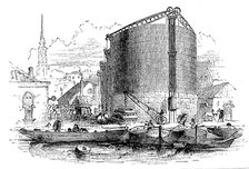 Exterior view of City of London Gasworks, showing gasometers and coal barges at the quay, 1876. Artist: Unknown