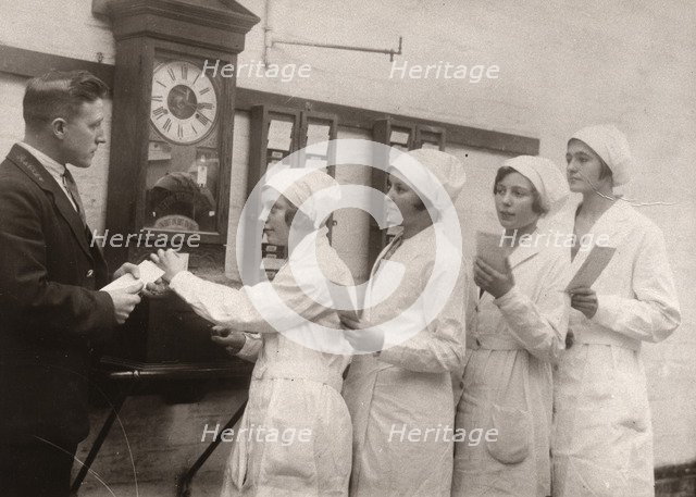 Girls queue at the Clocking-In machine, Rowntree factory, York, Yorkshire, 1933. Artist: Unknown