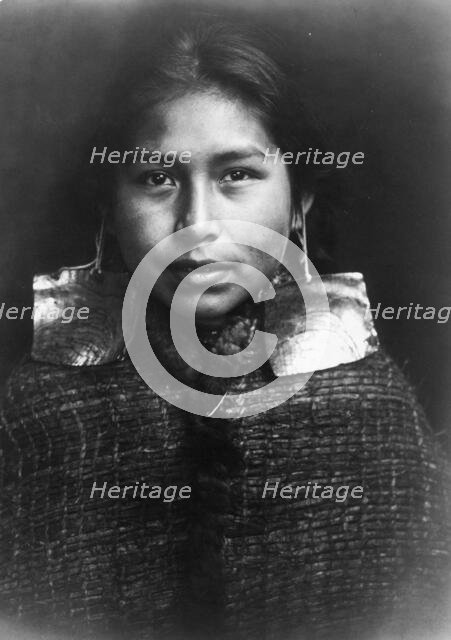 Tsawatenok girl, head-and-shoulders portrait, facing front, c1914. Creator: Edward Sheriff Curtis.