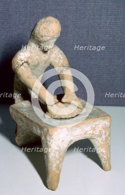 Greek terracotta of a woman making bread. Artist: Unknown