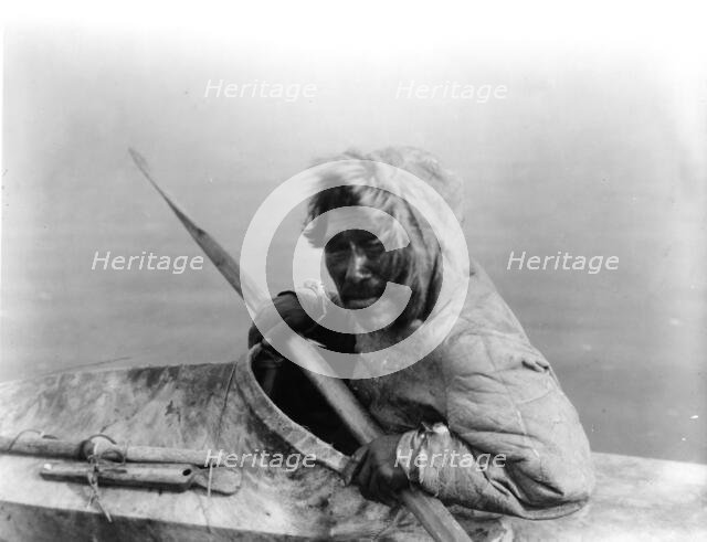 The seal-hunter, Noatak, in kayak, facing left, c1929. Creator: Edward Sheriff Curtis.