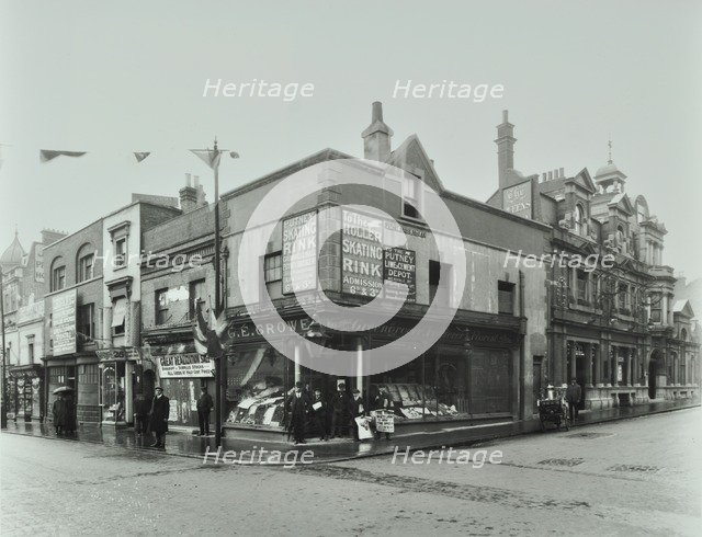 Shops and sign to Putney Roller Skating Rink, Putney Bridge Road, London, 1911. Artist: Unknown.