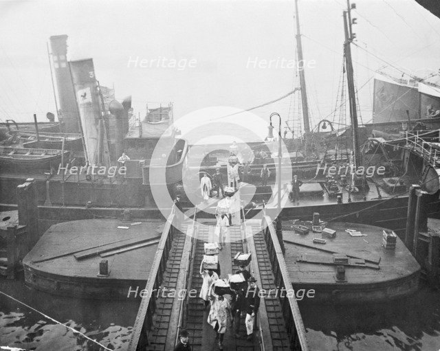 Unloading a fishing boat, Billingsgate market, London, 1923. Artist: Unknown