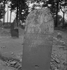 Tombstone in a red clay Negro cemetery, Person County, North Carolina, 1939. Creator: Dorothea Lange.
