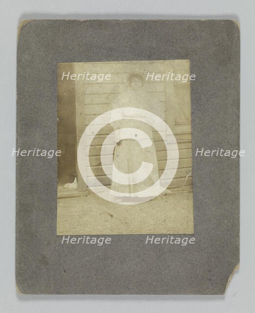 Photographic print of a woman in front of a building, late 19th century. Creator: Unknown.