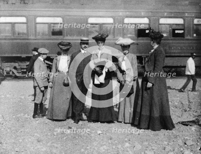 Group of people posed with railroad car behind them, Denver, Colorado, (1903?). Creator: Frances Benjamin Johnston.