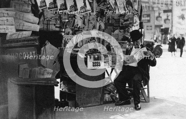 Newspaper stand, Paris, 1931.Artist: Ernest Flammarion