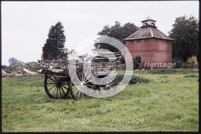 The dovecote to the south-west of Kentwell Hall seen with an old wooden wagon..., Long Melford, 1980 Creator: Dorothy Chapman.