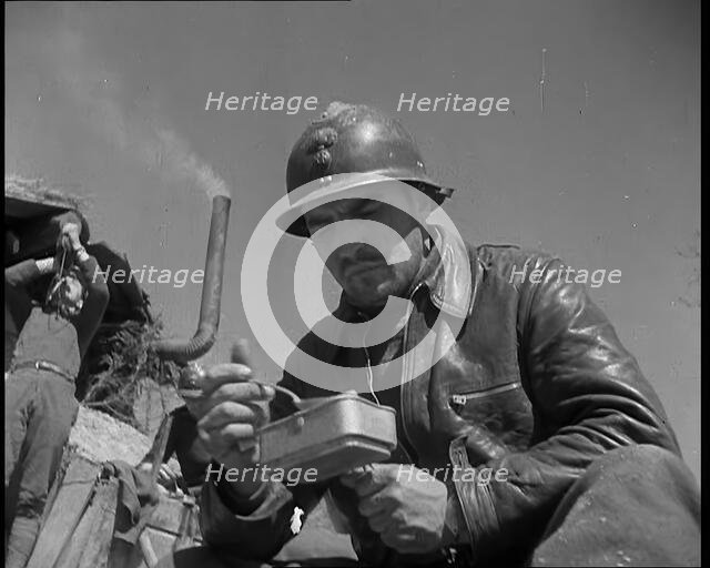 French Soldiers Eating a Meal in a Dug Out, 1940. Creator: British Pathe Ltd.