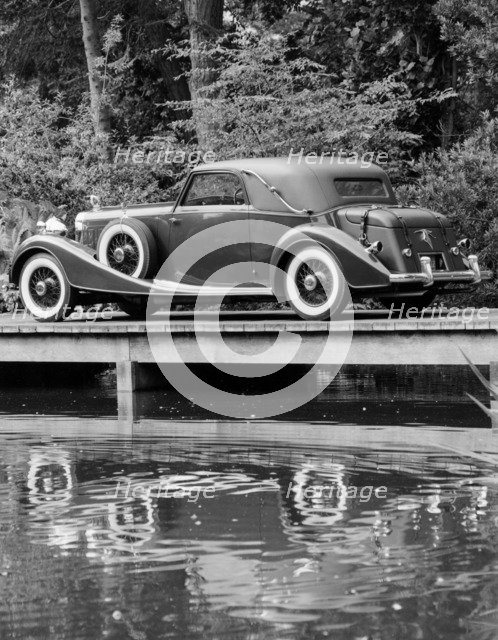A 1933 Hispano-Suiza K6 reflected in a lake. Artist: Unknown