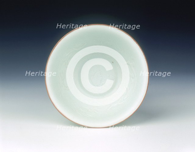 White glazed bowl with moulded design of dragons and carp, Qing dynasty, China, 1650-1670. Artist: Unknown