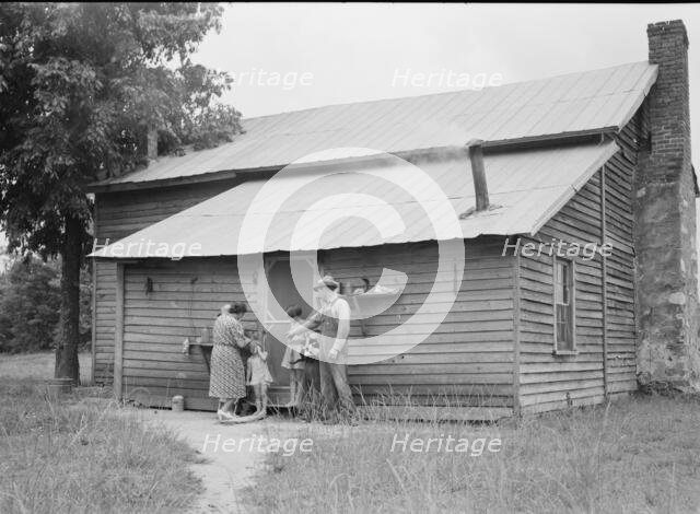 Tobacco sharecropper and his family at the back..., Person County, North Carolina, 1939. Creator: Dorothea Lange.