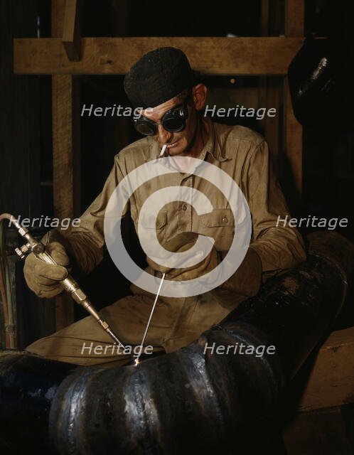 Gas welding a joint in a line...at the TVA's new Douglas Dam on the French Broad River, Tenn., 1942. Creator: Alfred T Palmer.