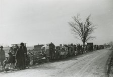 Evicted African American sharecroppers standing with their belongings along Highway 60..., Jan 1939. Creators: Farm Security Administration, Arthur Rothstein.