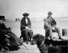 A physically disabled boy sitting in a wheelchair on a beach,  c1910/1925. Creator: Unknown.