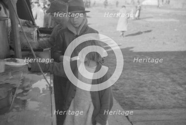 Possibly: Negroes in the lineup for food at mealtime in the camp..., Forrest City, Arkansas, 1937. Creator: Walker Evans.