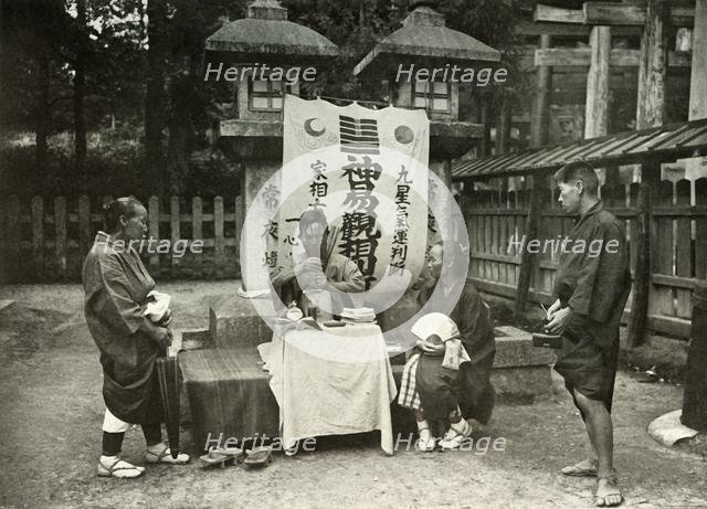 'A Fortune-Teller at Inari Temple', 1910. Creator: Herbert Ponting.