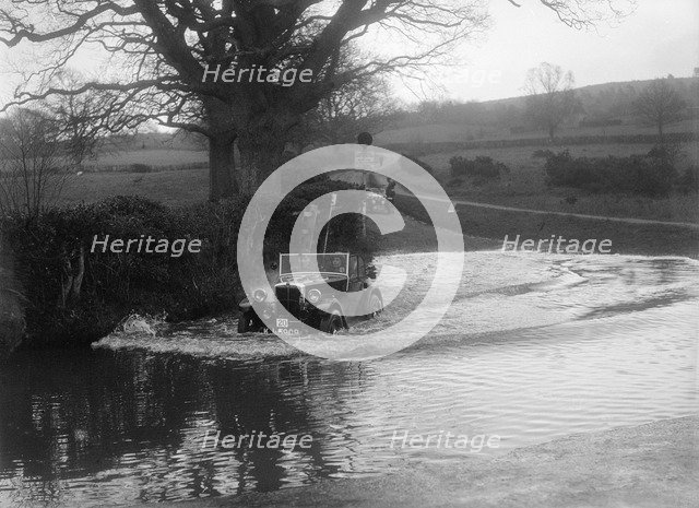 1932 Morris Minor tourer driving through a ford during a motoring trial, 1936. Artist: Bill Brunell.