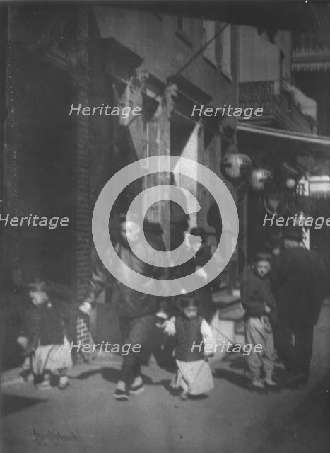 Man and two boys walking along a street, Chinatown, San Francisco, between 1896 and 1906. Creator: Arnold Genthe.