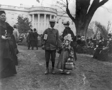 D.C. Wash. - White House - Negro boy holding hand of small white girl during Easter egg roll, 1898. Creator: Frances Benjamin Johnston.