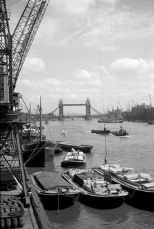 Tower Bridge with shipping in the Pool of London and vessels at Hay's Wharf, Southwark, c1945-c1965. Artist: SW Rawlings
