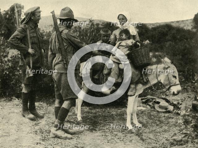 Australian soldier giving water to a Turkish family, First World War, 1915-1916, (c1920). Creator: Unknown.