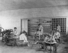 Classroom scenes at Carlisle, Pa., Indian School. Shoe making and repairing; male students, 1901. Creator: Frances Benjamin Johnston.