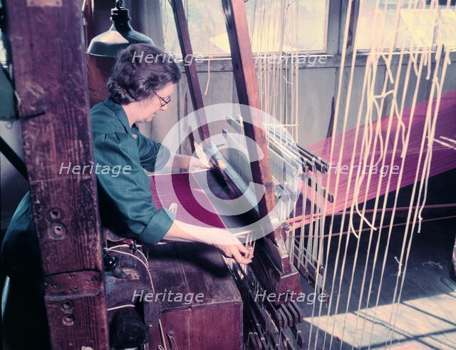 Women at a loom weaving cloth for state robes to be worn at the coronation of Elizabeth II, 1953. Creator: Arthur Charles Kirby Ware.