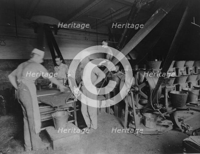 Workers grinding and processing the ink used to print paper money at the Bureau of Engrav..., c1890. Creator: Frances Benjamin Johnston.
