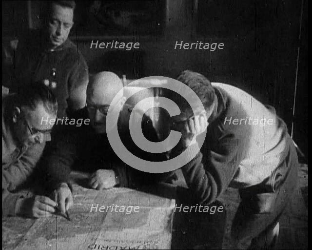 Four Men Consulting a Map in an Office, 1937. Creator: British Pathe Ltd.