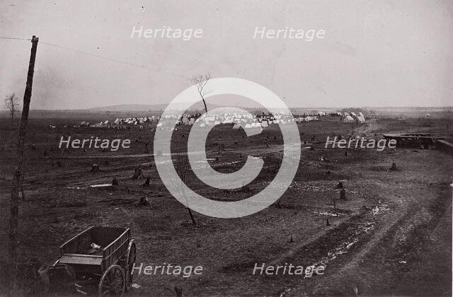 [Wagon in a landscape with army encampment in the distance]. Brady album, p. 125, 1861-65. Creator: Unknown.
