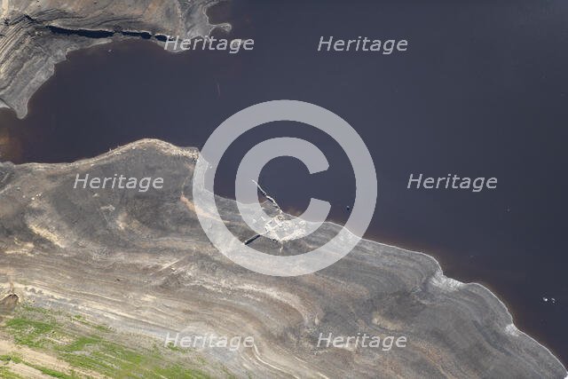 A ruined building revealed by low water levels at Howden Reservoir, Sheffield, 2022. Creator: Emma Trevarthen.