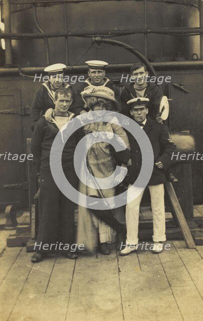 Six sailors, one in drag, pose for a group portrait on the deck of HMS St...(between 1910 and 1919?) Creator: Unknown.