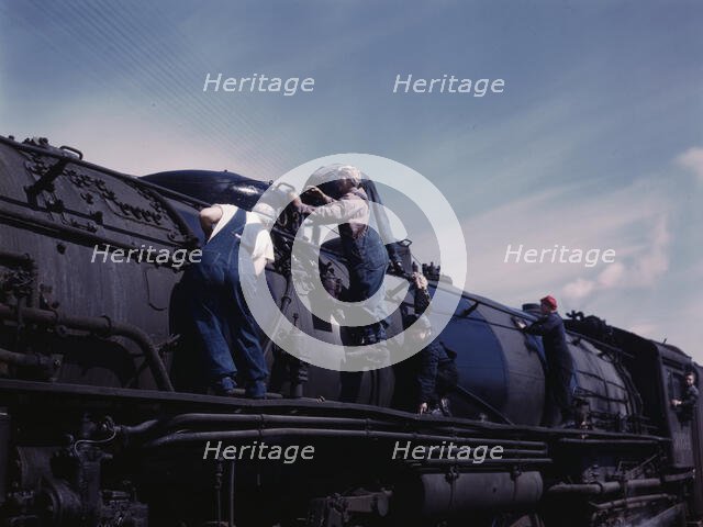 C. & N.W. R.R., women wipers employed at the roundhouse cleaning one of the..., Clinton, Iowa, 1943. Creator: Jack Delano.
