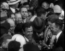 Jim Mollison Walking Surrounded by a Large Crowd, 1930s. Creator: British Pathe Ltd.