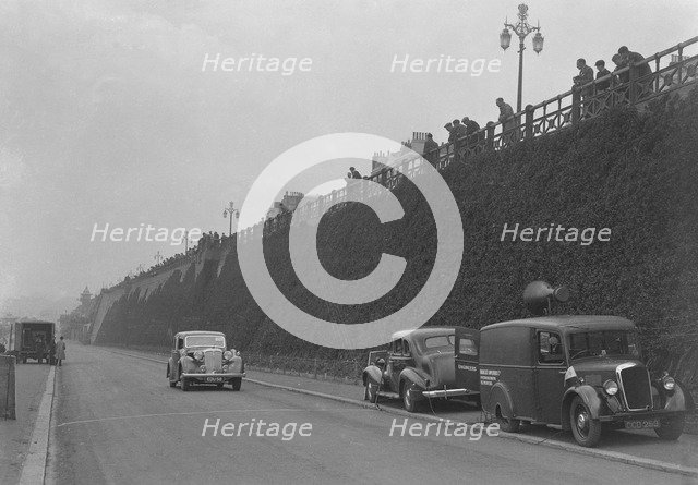 Daimler of CM Simpson and a Morris loudspeaker van on Madeira Drive, Brighton, RAC Rally, 1939. Artist: Bill Brunell.