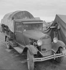 Truck, baby parked on front seat, FSA camp, Merrill, Klamath County, Oregon, 1939. Creator: Dorothea Lange.