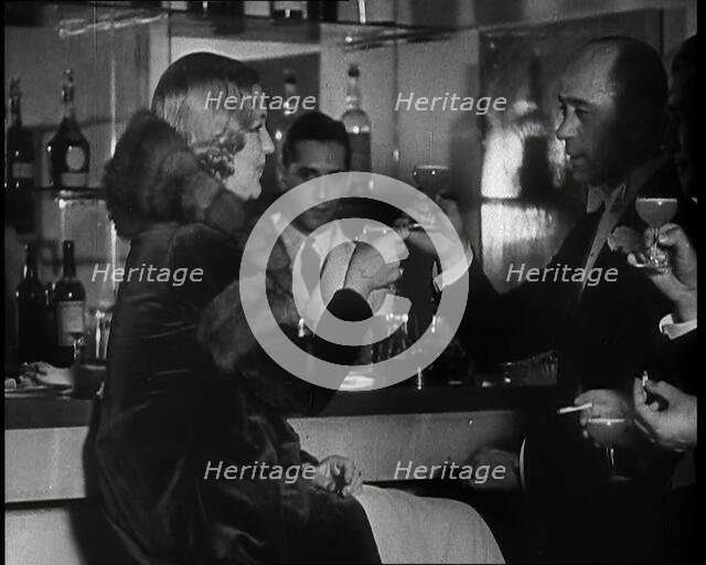 A Man and a Woman Drinking at a Nightclub, 1930s. Creator: British Pathe Ltd.