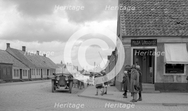 Parked car and children on a street corner, Landskrona, Sweden, 1925. Artist: Unknown