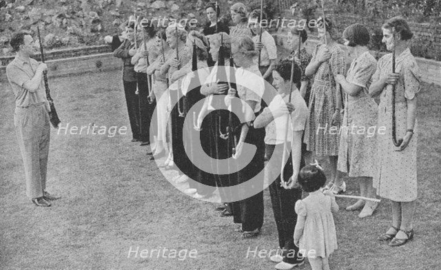 Members of the Women's Volunteer Defence Corps being trained in rifle drill, World War II, 1940. Artist: Unknown