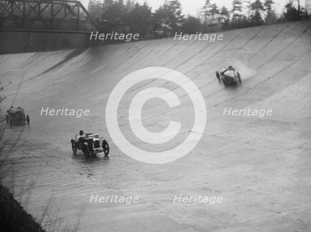 Austin 7 and the spinning Riley of HL Roberts, BARC Mountain Race, Brooklands, Surrey, 1931 Artist: Bill Brunell.