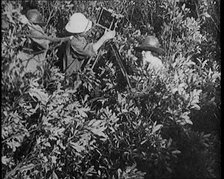 Female Civilians Wearing Explorers Outfit Setting up a Camera to Record Nature Life in the..., 1920. Creator: British Pathe Ltd.