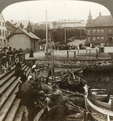 'Buying fish in a busy Arctic trading port, Tromsoe (69° 38' N. Lat.), Northern Norway', 1902. Creator: Unknown.