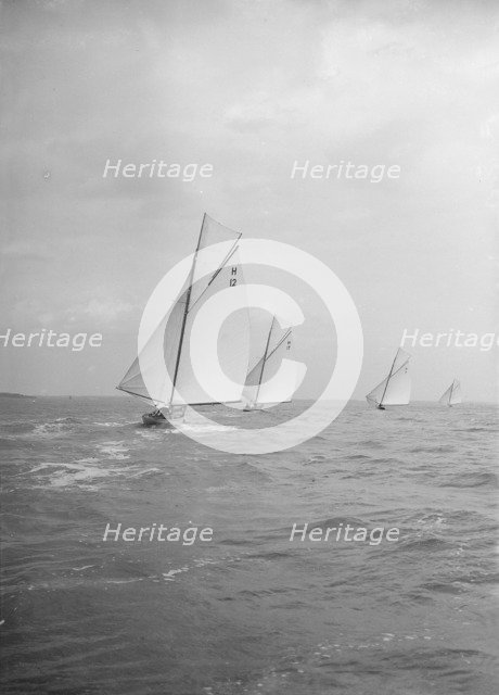 Group of 8 Metres sailing yachts racing downwind, 1913. Creator: Kirk & Sons of Cowes.