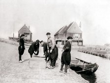 Men and boys in traditional costume by a canal bank, Marken Island, Netherlands, 1898. Artist: James Batkin