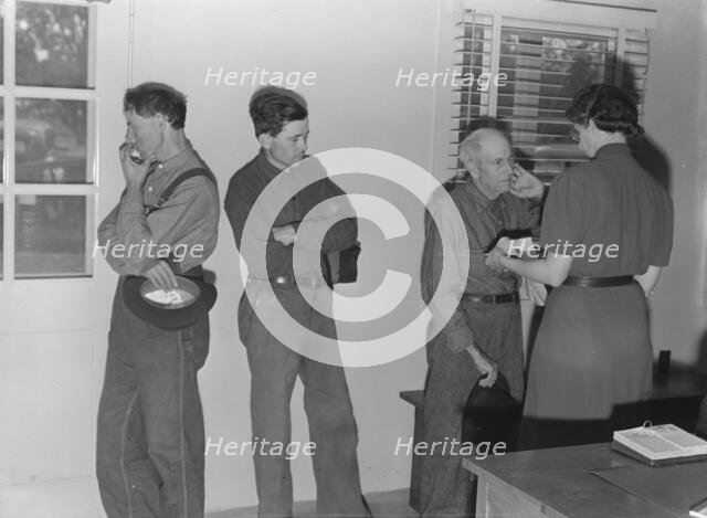 Sons, migratory workers, bring father...to the camp clinic, FSA camp, Tulare County, CA, 1939. Creator: Dorothea Lange.