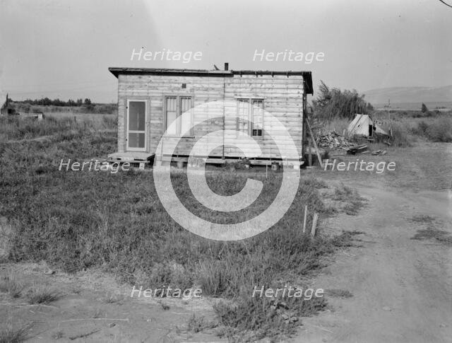 Homes are built bit by bit with whatever materials are available, Yakima,Washington, 1939. Creator: Dorothea Lange.
