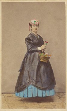 Unidentified woman wearing a flowered hat, holding single flower in one hand, basket of...1862-1865. Creator: Carlo Ponti.